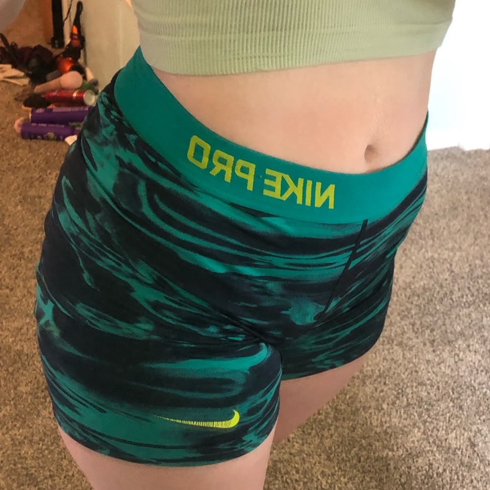 these are turquoise, blue, and neon yellow nike pros, gently worn